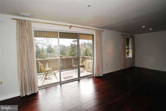 120 Cross Keys Road, Unit R120F Baltimore, MD 21210 - Photo 4 of 17 an empty room with wooden floor and windows