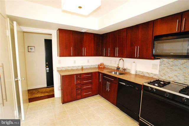 120 Cross Keys Road, Unit R120F Baltimore, MD 21210 - Photo 7 of 17 a kitchen with wooden cabinets and a sink