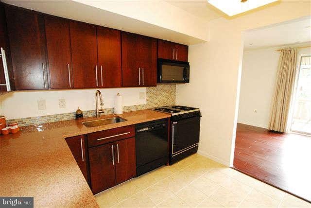 120 Cross Keys Road, Unit R120F Baltimore, MD 21210 - Photo 8 of 17 a kitchen with a sink and a stove top oven