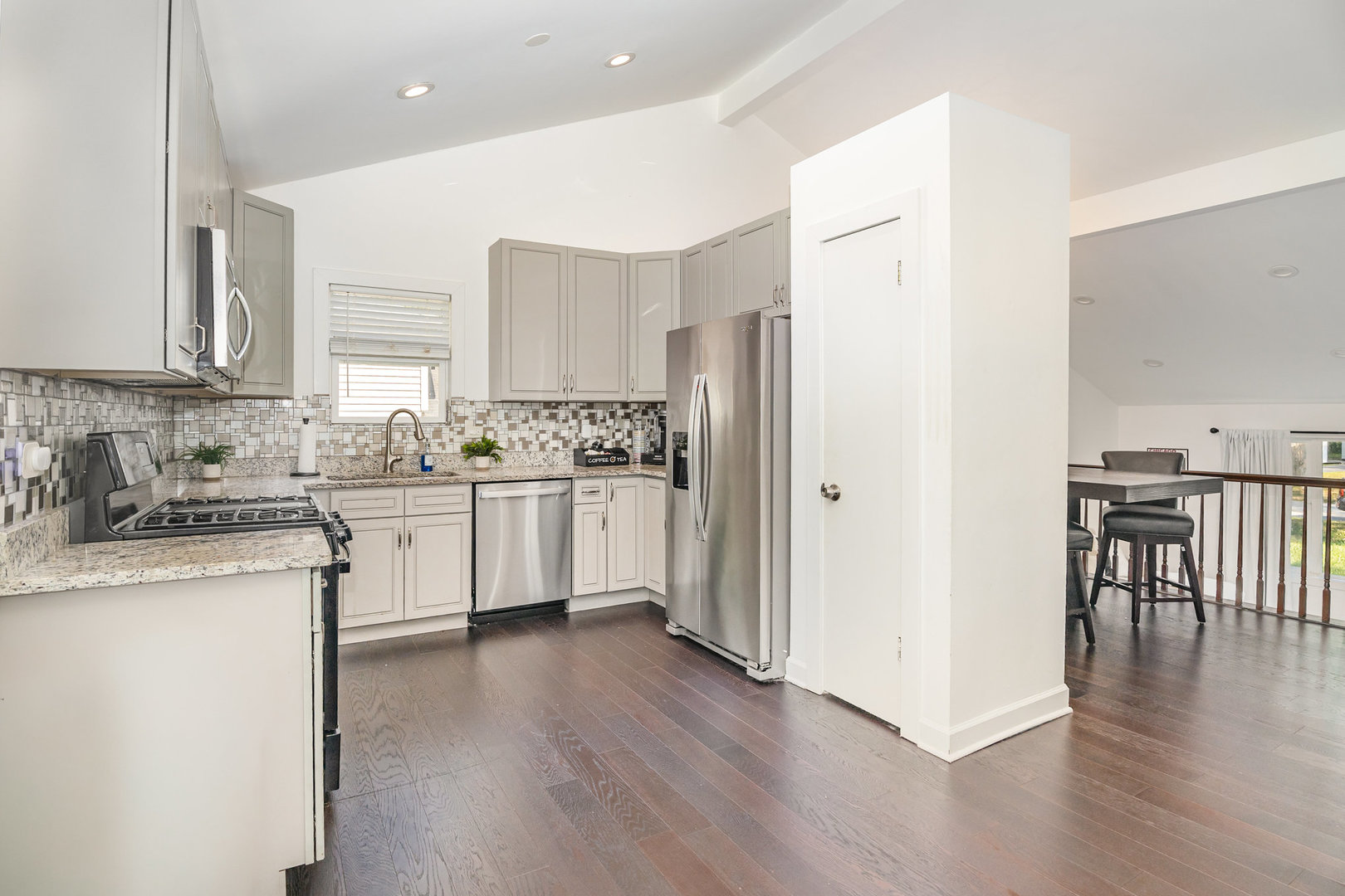 16314 Homan Avenue Markham, IL 60428 - Photo 13 of 32 a kitchen with stainless steel appliances granite countertop a refrigerator a sink dishwasher a stove with wooden floor and cabinets