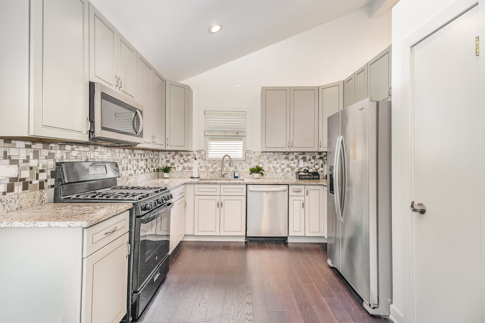16314 Homan Avenue Markham, IL 60428 - Photo 14 of 32 a kitchen with stainless steel appliances granite countertop a stove a sink dishwasher a refrigerator and white cabinets with wooden floor