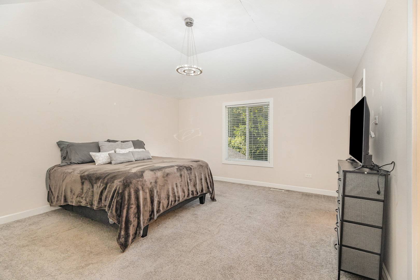 16314 Homan Avenue Markham, IL 60428 - Photo 16 of 32 a spacious bedroom with a bed and a flat screen tv