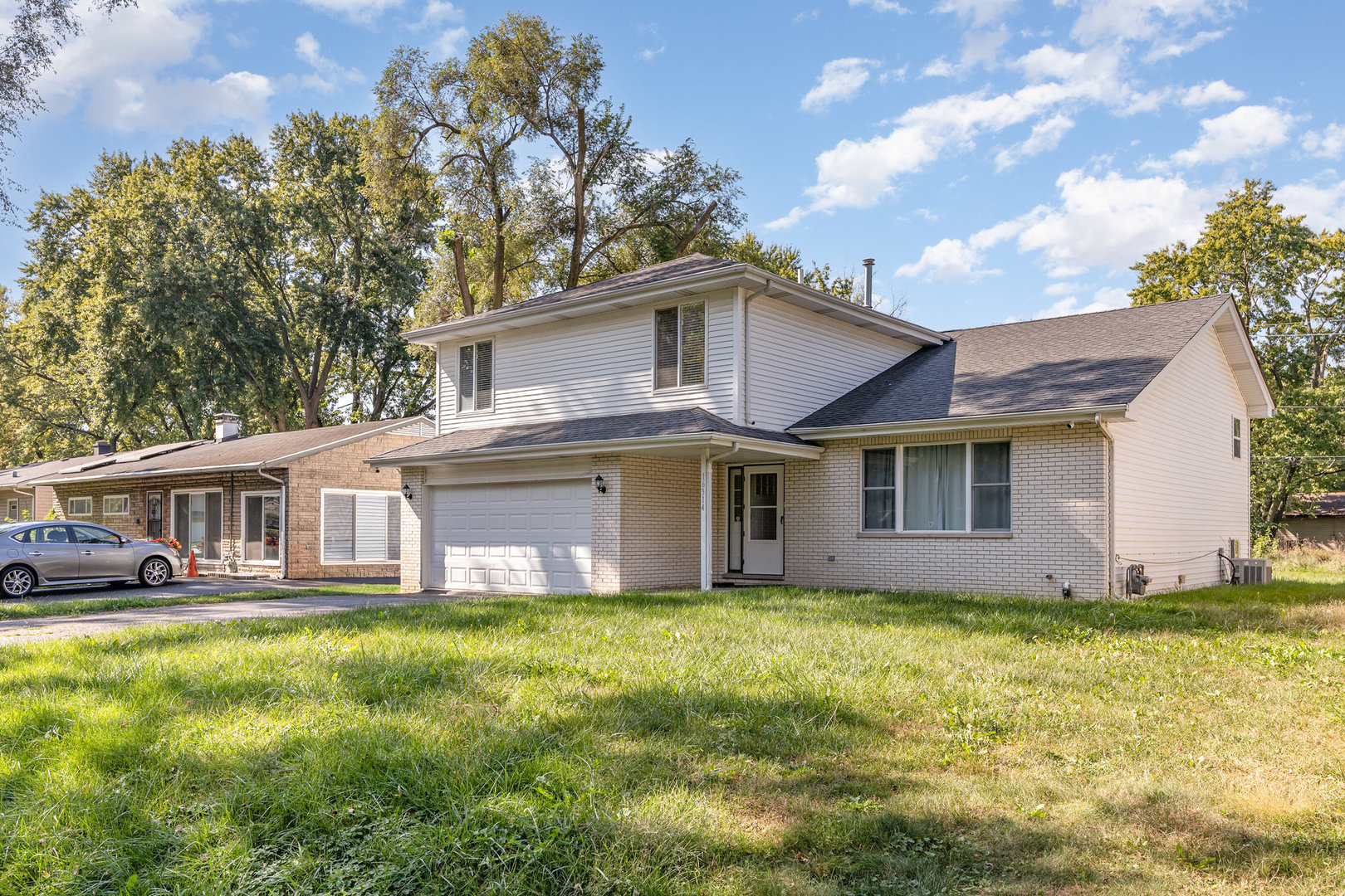 16314 Homan Avenue Markham, IL 60428 - Photo 2 of 32 a front view of house with yard and trees in the background