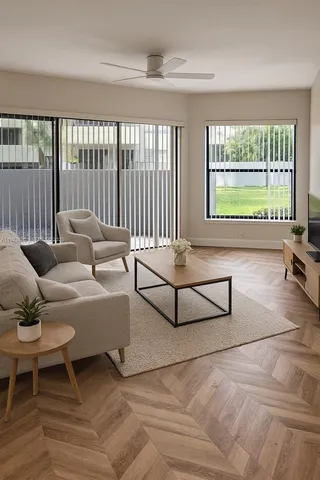 a living room with furniture and a large window