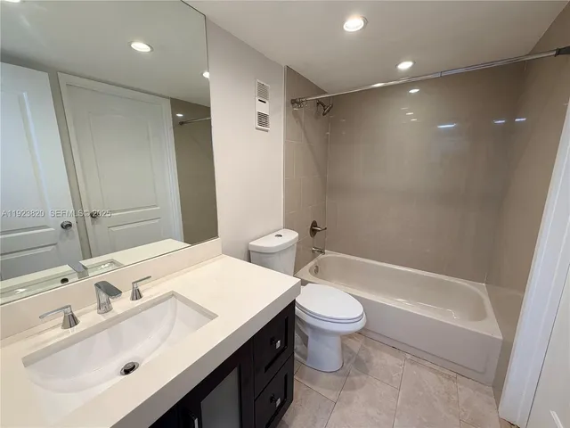 a bathroom with a sink toilet tub and shower