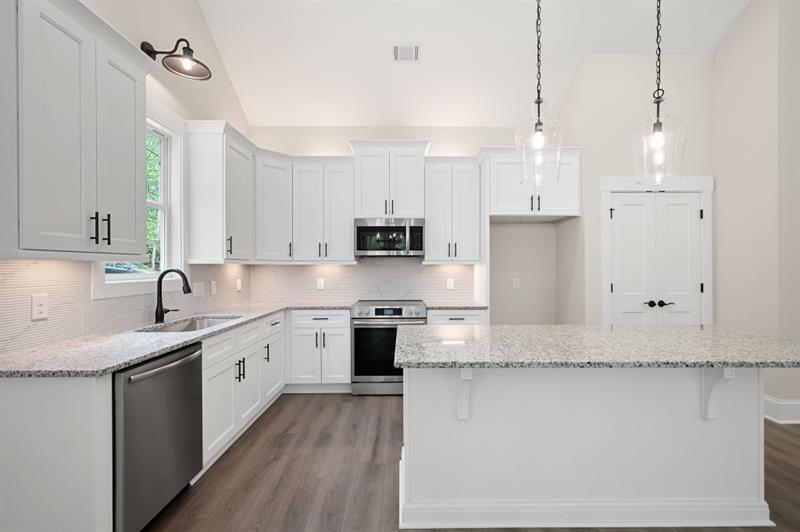 110 Doris Path Temple, GA 30179 - Photo 11 of 35 a kitchen with stainless steel appliances granite countertop a sink a stove a refrigerator and white cabinets