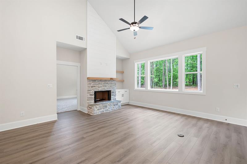 110 Doris Path Temple, GA 30179 - Photo 15 of 35 an empty room with windows fireplace and wooden floor