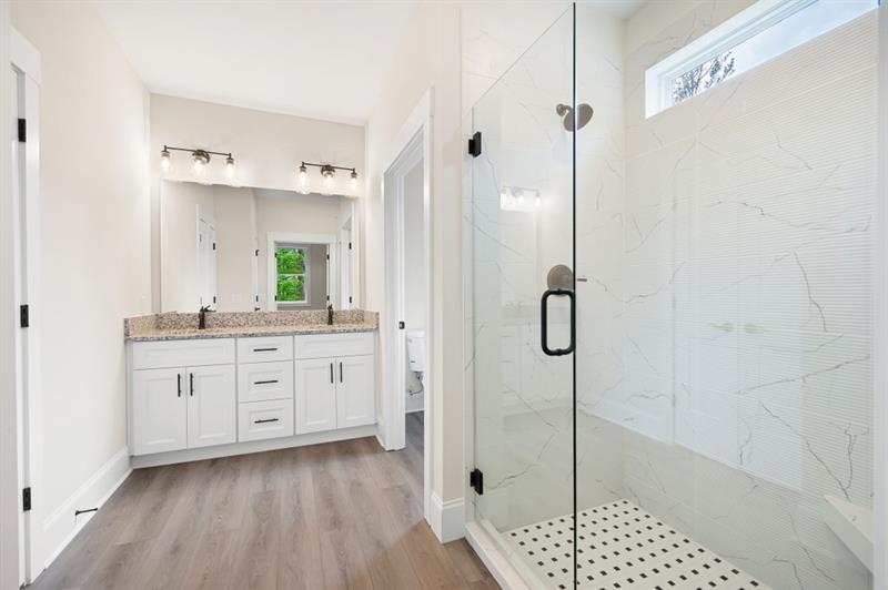 110 Doris Path Temple, GA 30179 - Photo 19 of 35 a spacious bathroom with a granite countertop sink a mirror a vanity and a shower