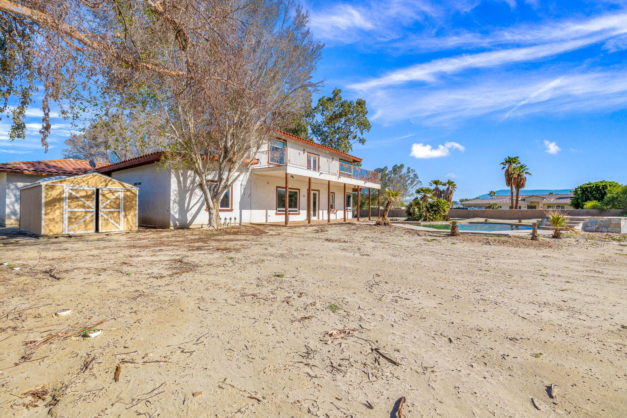 48755 Southview Place Indio, CA 92201 - Photo 15 of 55 a view of road with large trees