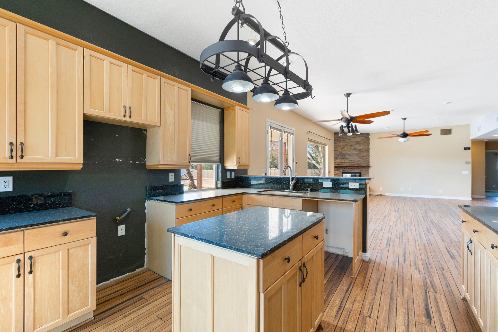 48755 Southview Place Indio, CA 92201 - Photo 22 of 55 a kitchen with stainless steel appliances granite countertop a sink dishwasher and a stove with wooden floor