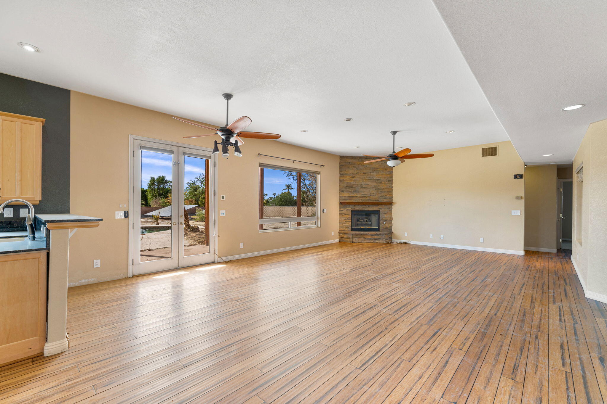 48755 Southview Place Indio, CA 92201 - Photo 23 of 55 a view of a living room and kitchen with wooden floor