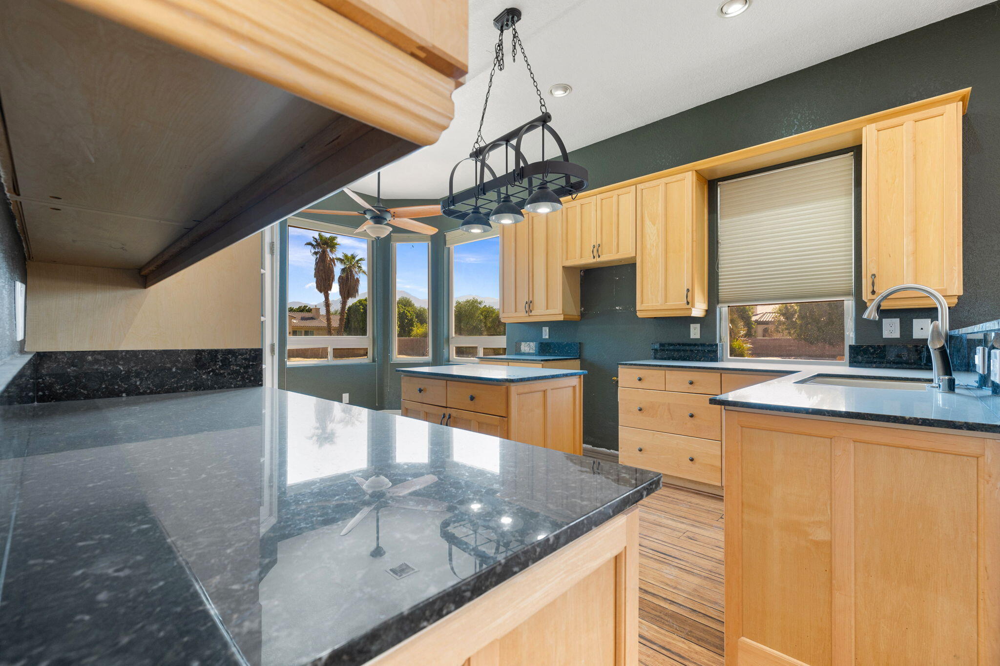 48755 Southview Place Indio, CA 92201 - Photo 29 of 55 a kitchen with stainless steel appliances granite countertop a sink a stove top oven a counter space and cabinets