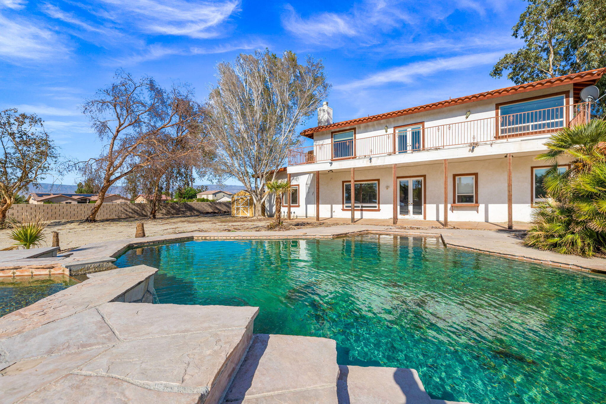 48755 Southview Place Indio, CA 92201 - Photo 3 of 55 a front view of a house with garden
