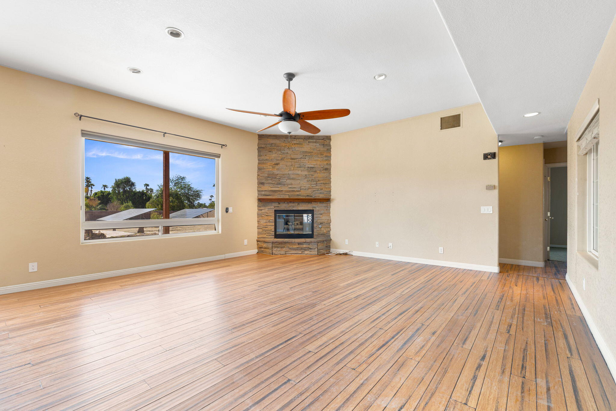 48755 Southview Place Indio, CA 92201 - Photo 32 of 55 wooden floor in an empty room with a window