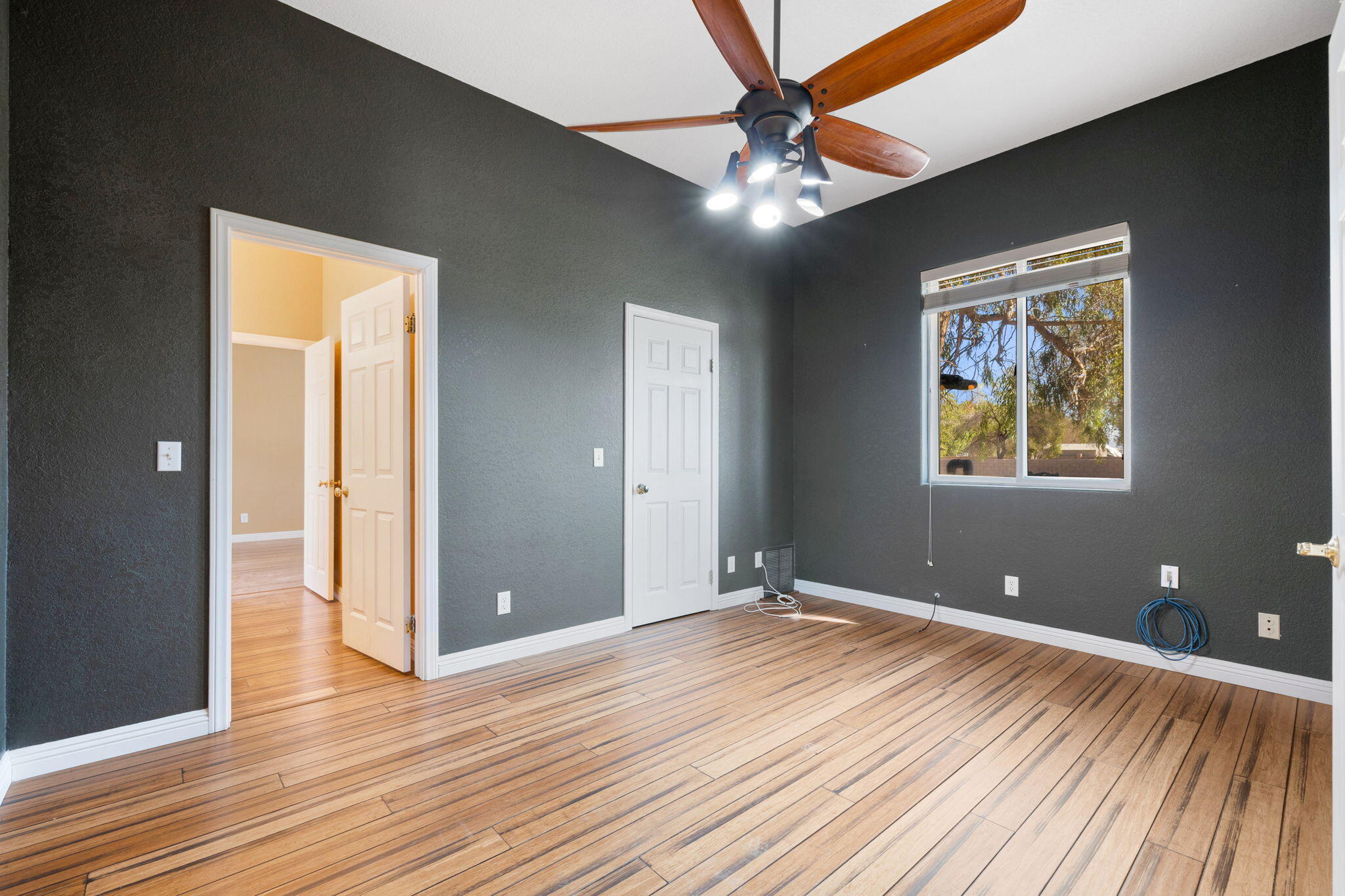 48755 Southview Place Indio, CA 92201 - Photo 43 of 55 a view of a room with wooden floor and ceiling fan