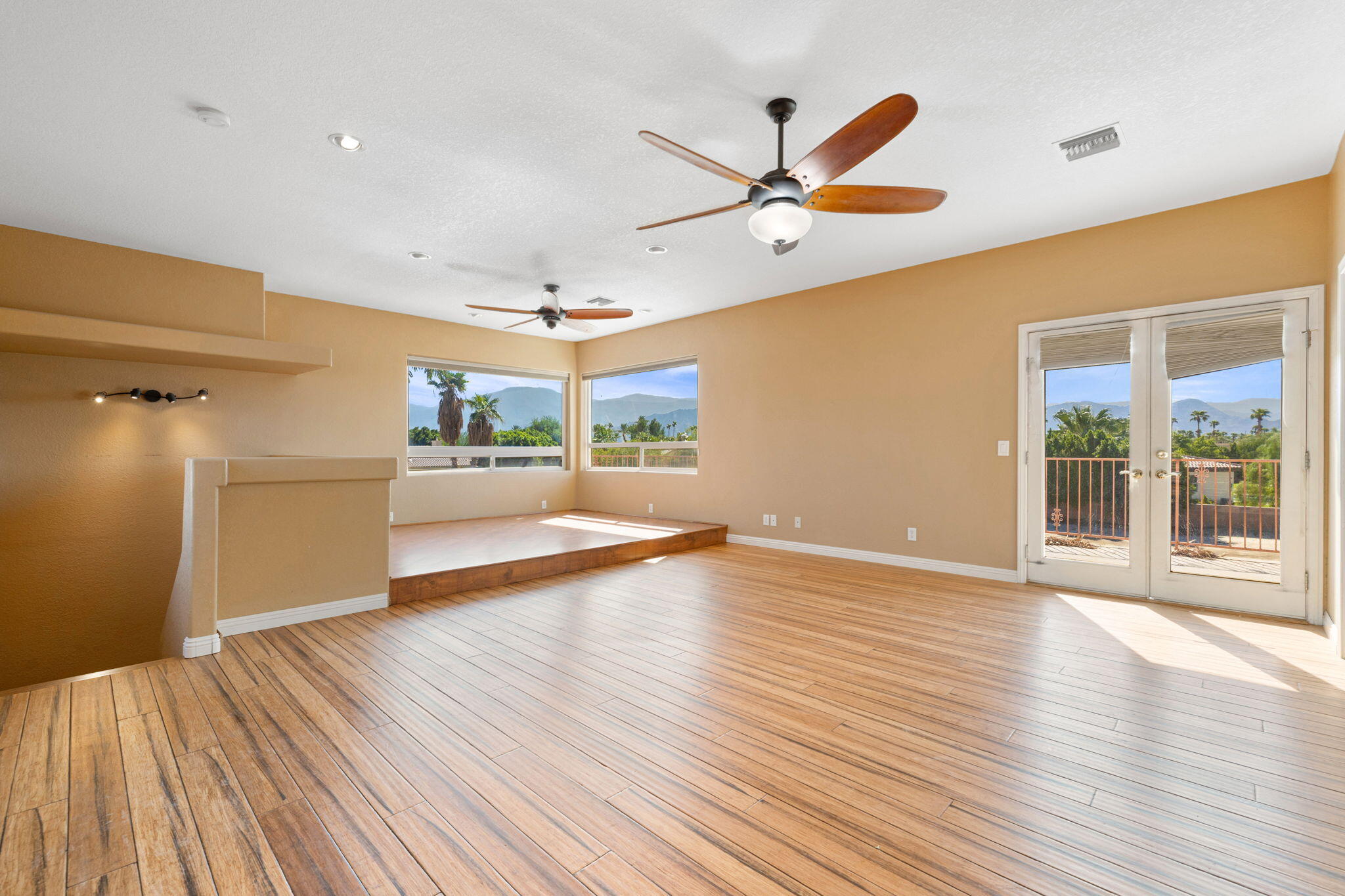 48755 Southview Place Indio, CA 92201 - Photo 47 of 55 a view of a livingroom with wooden floor and a ceiling fan