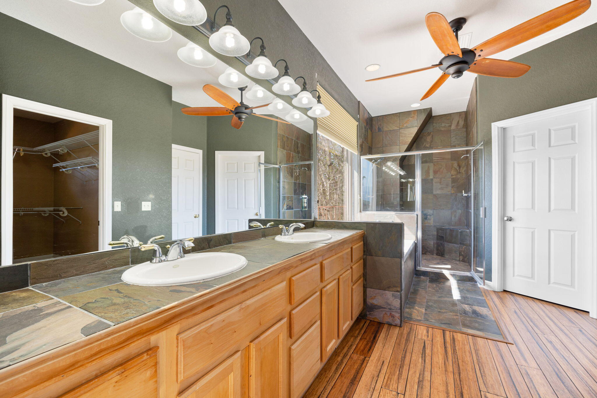 48755 Southview Place Indio, CA 92201 - Photo 50 of 55 a bathroom with a granite countertop sink a mirror and a shower