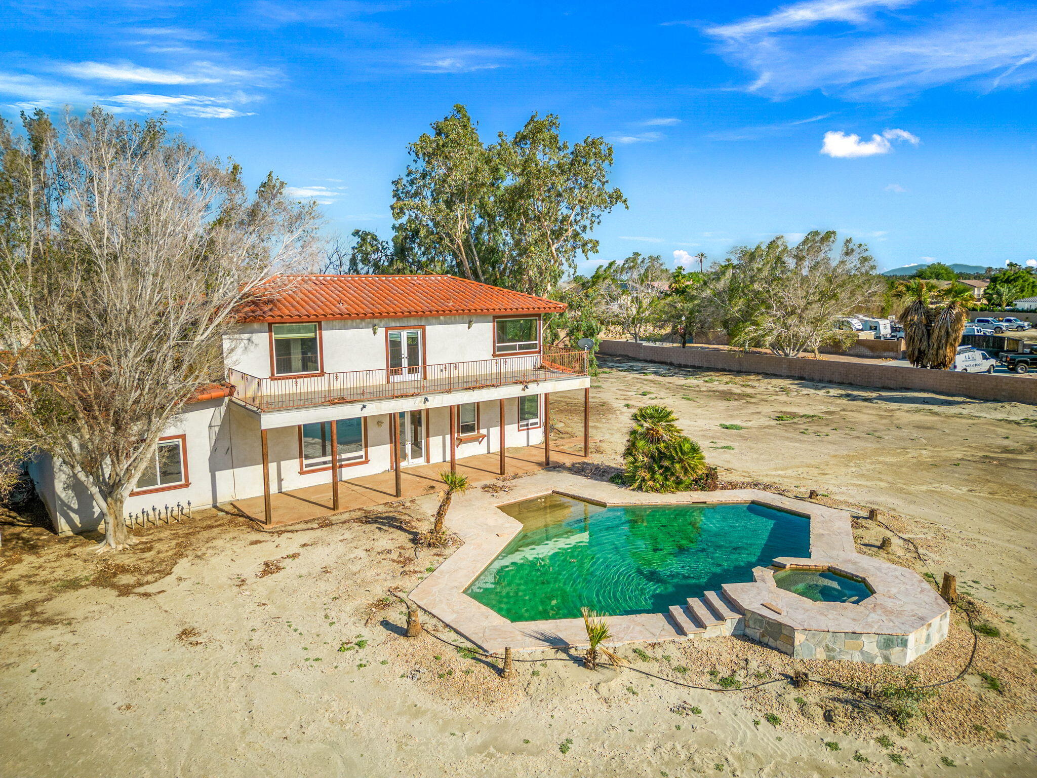 48755 Southview Place Indio, CA 92201 - Photo 5 of 55 a view of a lake with a house in the background