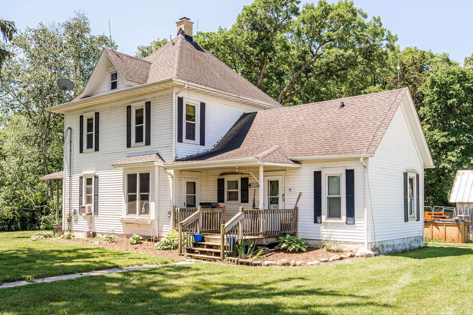 a front view of a house with a yard patio and swimming pool