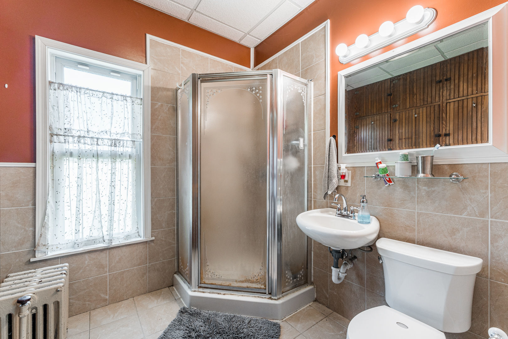 12757 Base Line Road Genoa, IL 60135 - Photo 14 of 49 a bathroom with a toilet sink shower and mirror