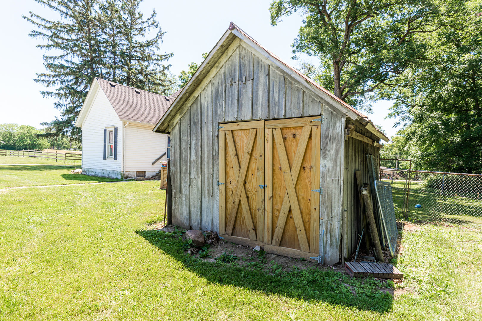 12757 Base Line Road Genoa, IL 60135 - Photo 46 of 49 a view of a small house in the yard with large trees