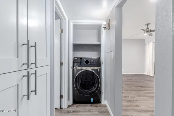 a view of a hallway with a washer and dryer