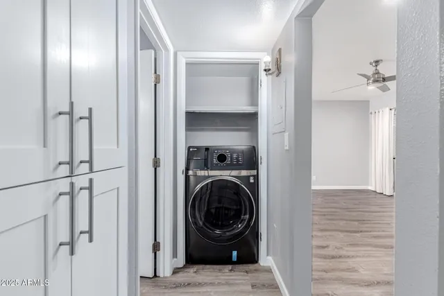 a view of a hallway with a washer and dryer