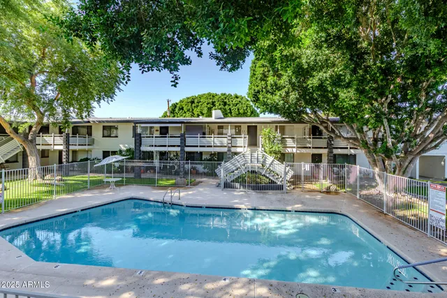 swimming pool view with a seating space and a garden view