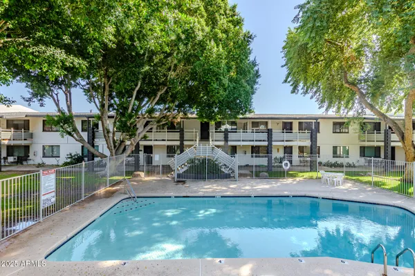 a house view with swimming pool and sitting space