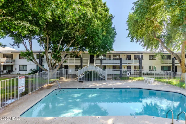 a house view with swimming pool and sitting space