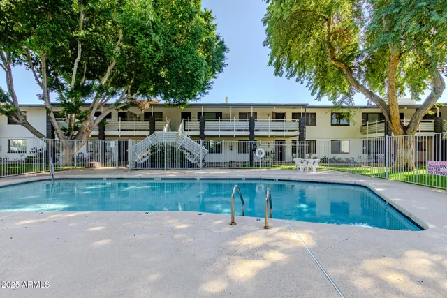 a view of a house with pool and a yard