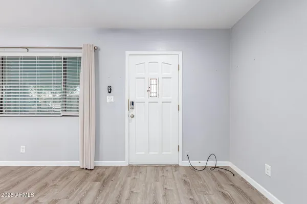 a view of room with hardwood floor and window
