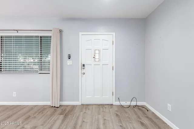 a view of room with hardwood floor and window