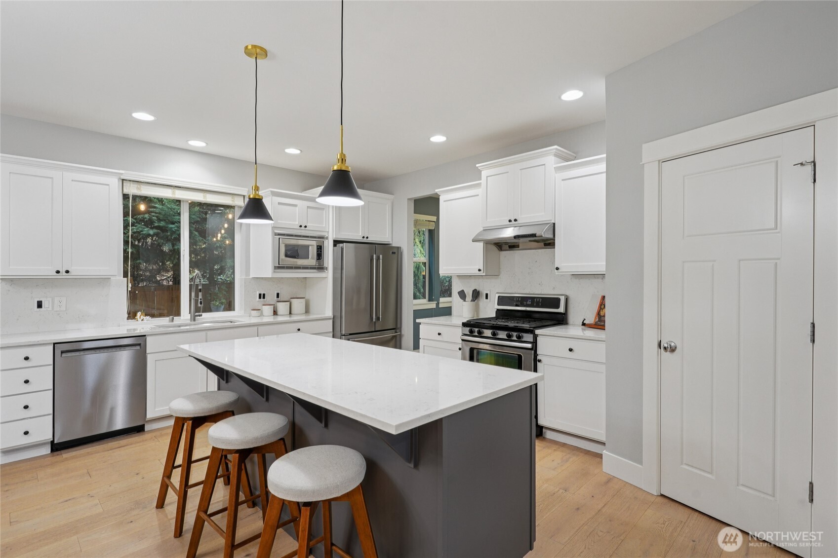 6523 128th Place Southwest Edmonds, WA 98026 - Photo 6 of 35 a kitchen with stainless steel appliances granite countertop a stove top oven a refrigerator a sink and chairs