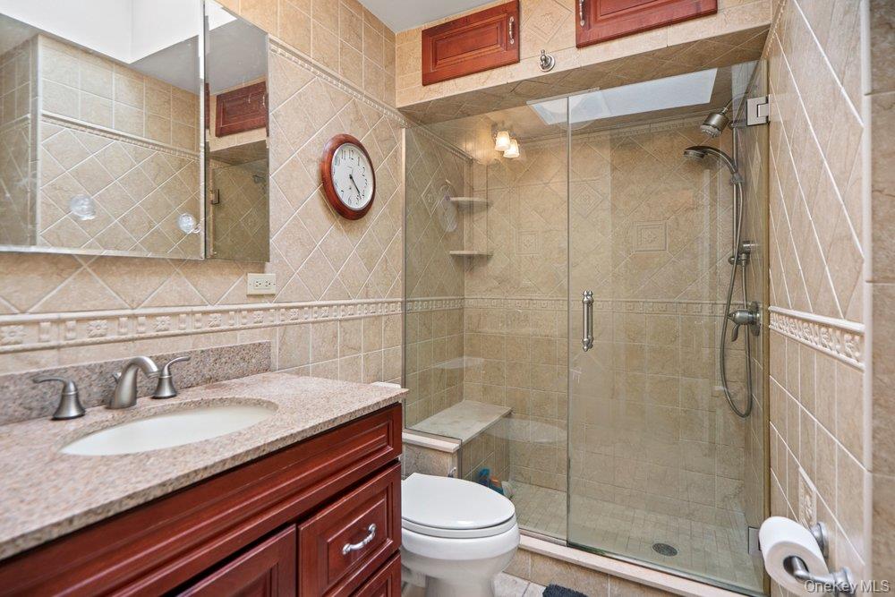 101 Sexton Road West Babylon, NY 11704 - Photo 18 of 33 a bathroom with a granite countertop sink toilet and shower
