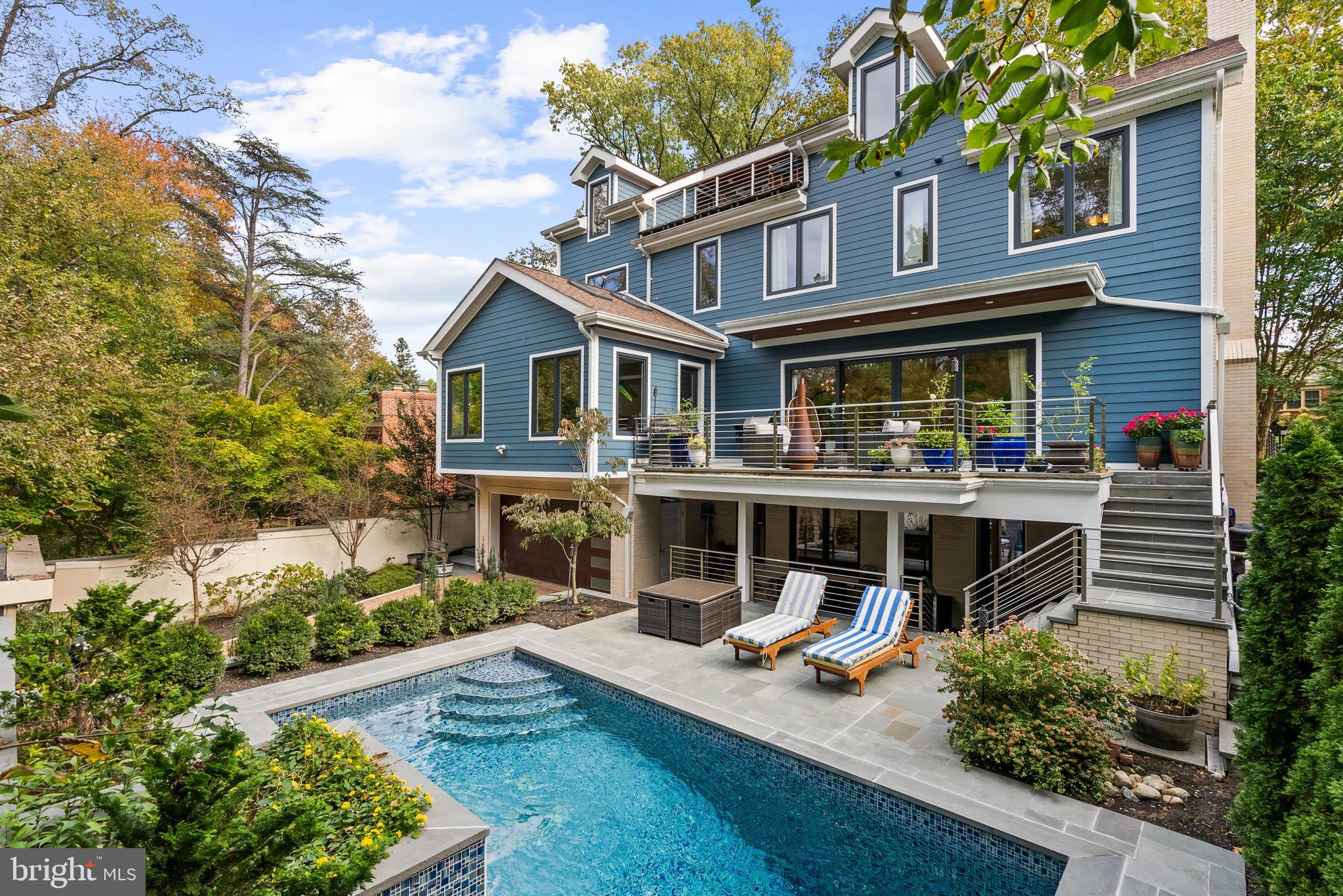 a view of a house with pool and sitting area