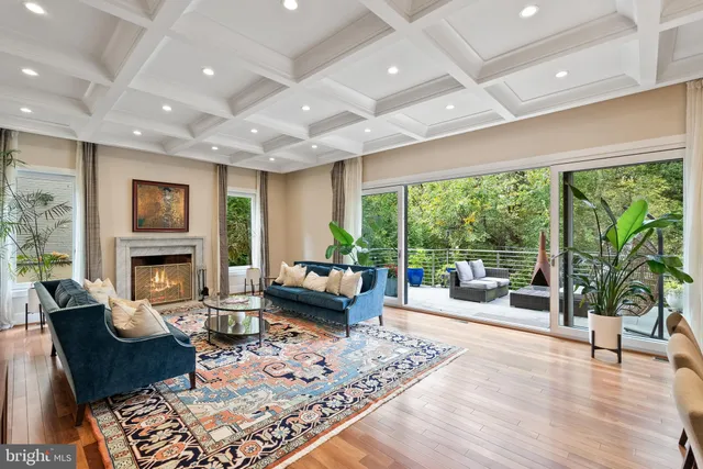 a living room with fireplace furniture and a large window