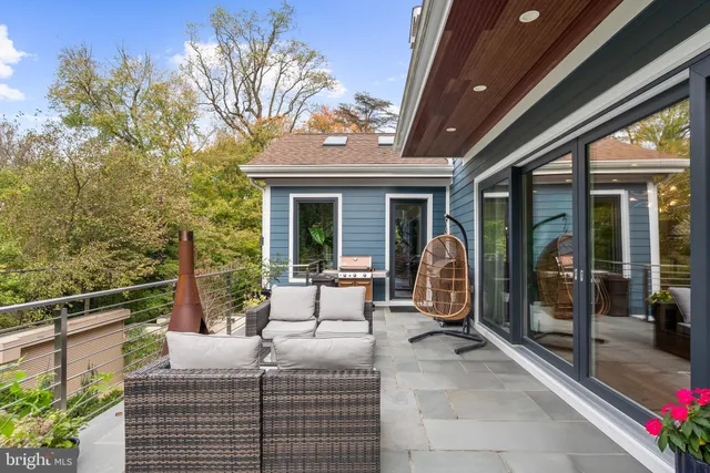 a view of a patio with couches chairs and potted plants