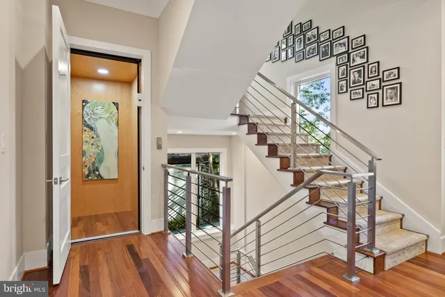 a view of entryway and hall with wooden floor