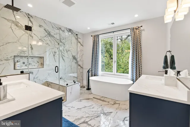 a spacious bathroom with sink shower and bathtub