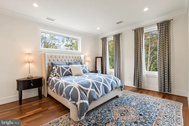 a bedroom with a bed lamp and window