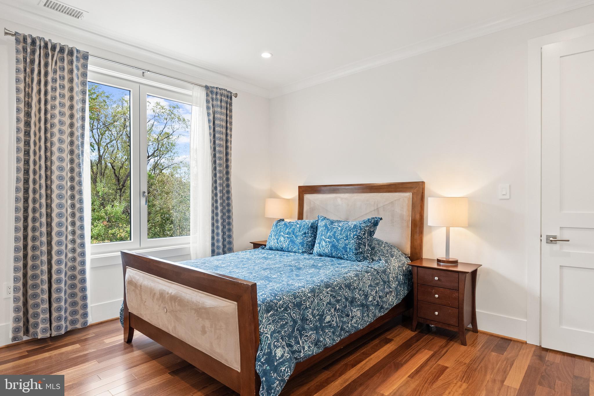 5152 Linnean Terrace Northwest Washington, DC 20008 - Photo 20 of 39 a bedroom with a bed and a window