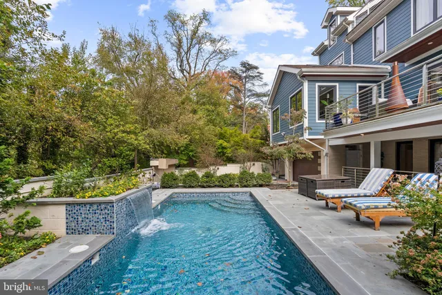a view of a patio with chair and tables back yard of the house