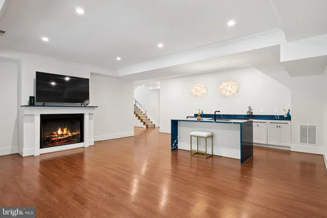 a living room with furniture a fireplace and a flat screen tv
