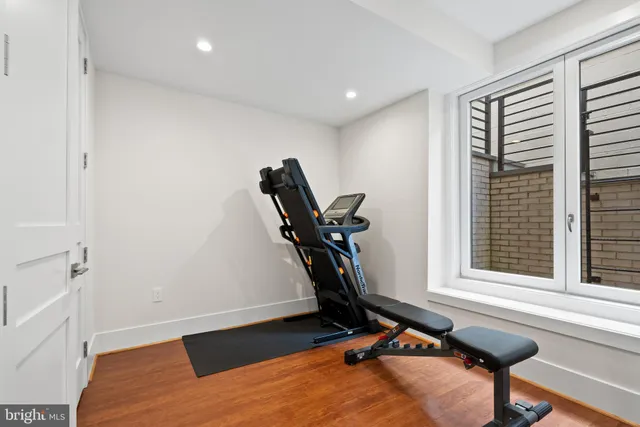 a room with gym equipment and windows