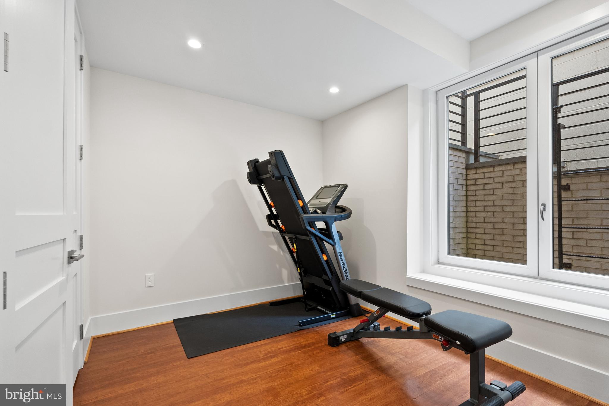 5152 Linnean Terrace Northwest Washington, DC 20008 - Photo 33 of 39 a room with gym equipment and windows