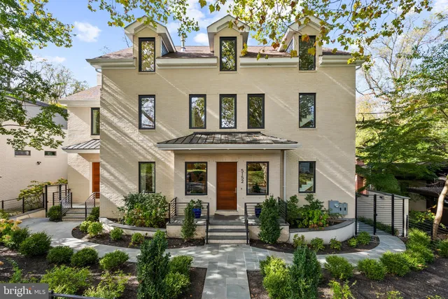 a front view of a house with a garden