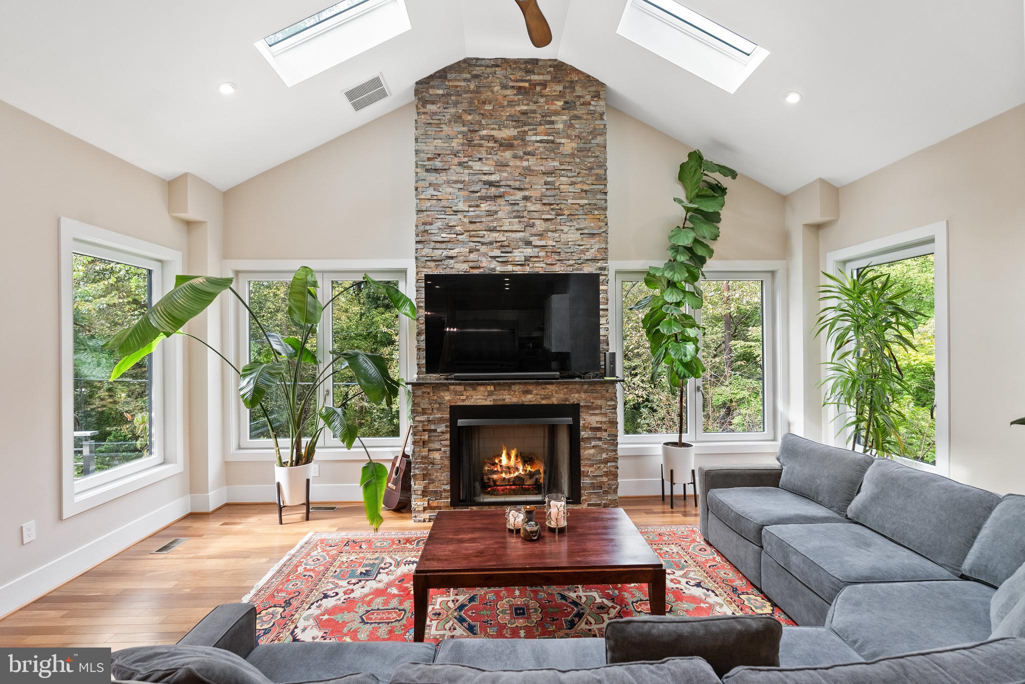 5152 Linnean Terrace Northwest Washington, DC 20008 - Photo 7 of 39 a living room with furniture a large window and a fireplace