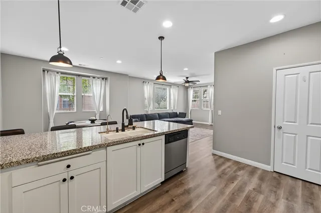a kitchen with a sink stove and cabinets