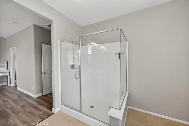 a bathroom with a glass shower door and a sink
